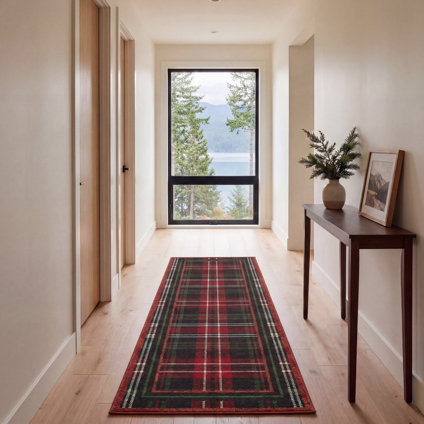 Hallway with a tartan runner, wooden console table, and large window overlooking nature.