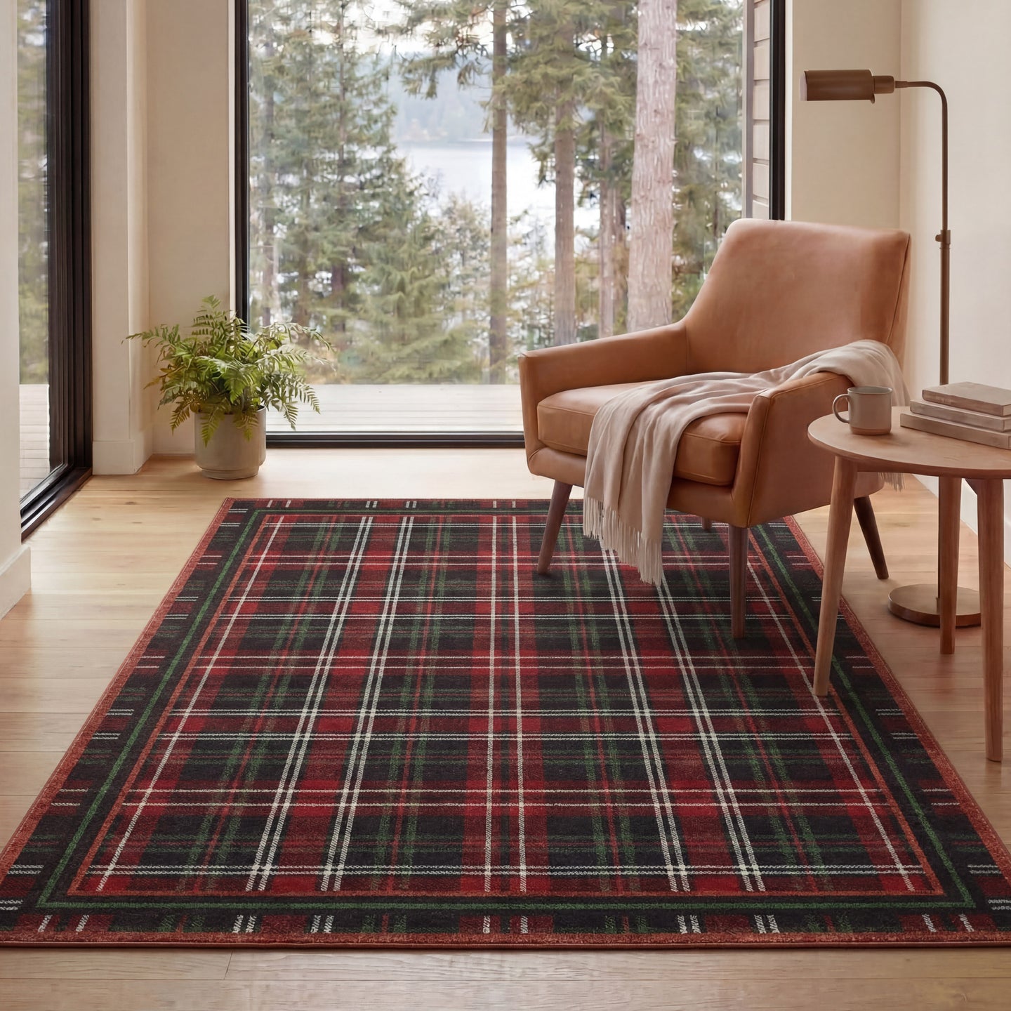 Living room with a plaid rug, brown armchair, and large windows overlooking trees.
