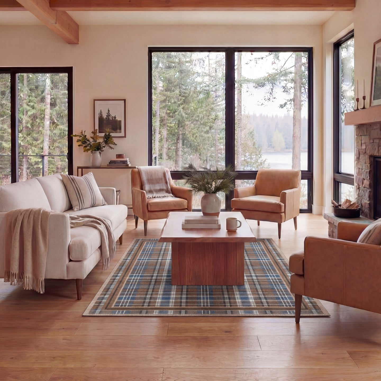 Cozy living room with beige sofa, brown armchairs, wooden coffee table, and large windows overlooking trees.