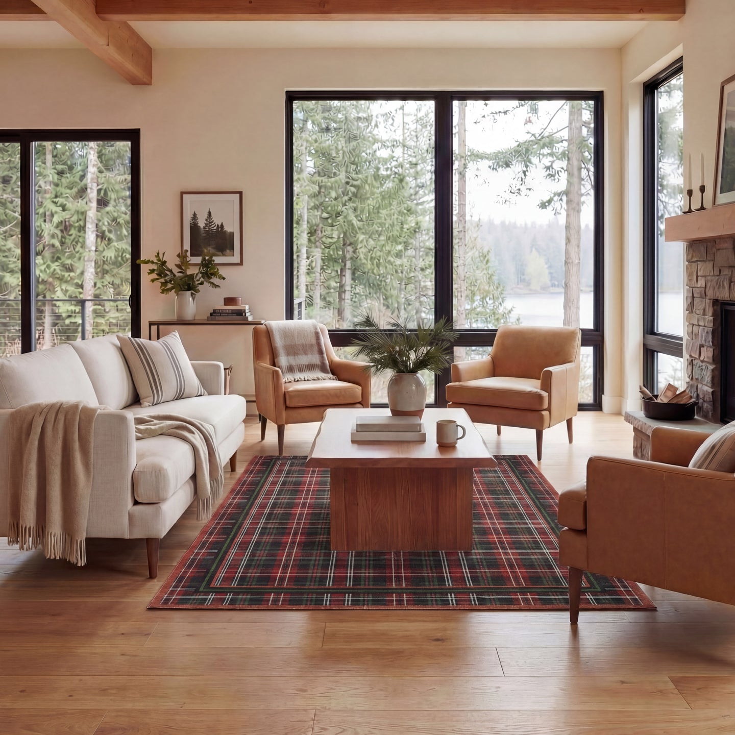 Living room with plaid rug, wooden coffee table, and large windows overlooking trees.