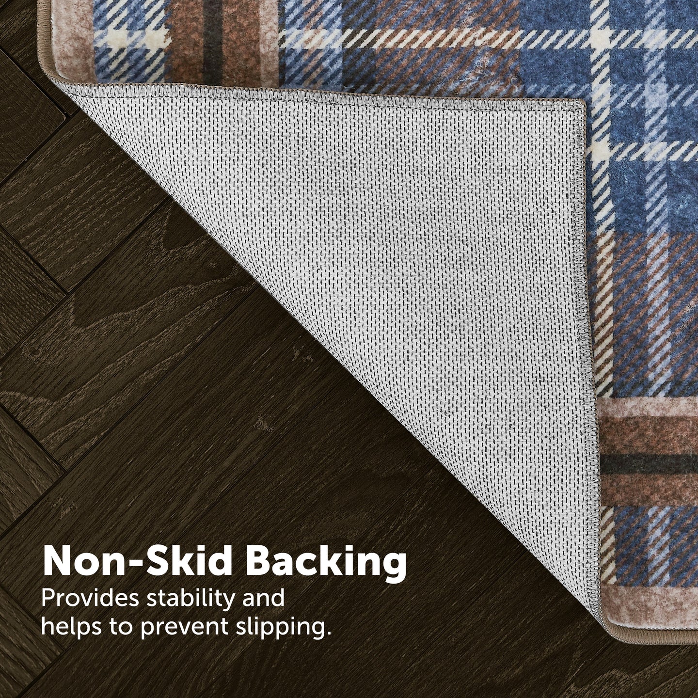 Rug with plaid border on wooden floor, highlighting non-skid backing.