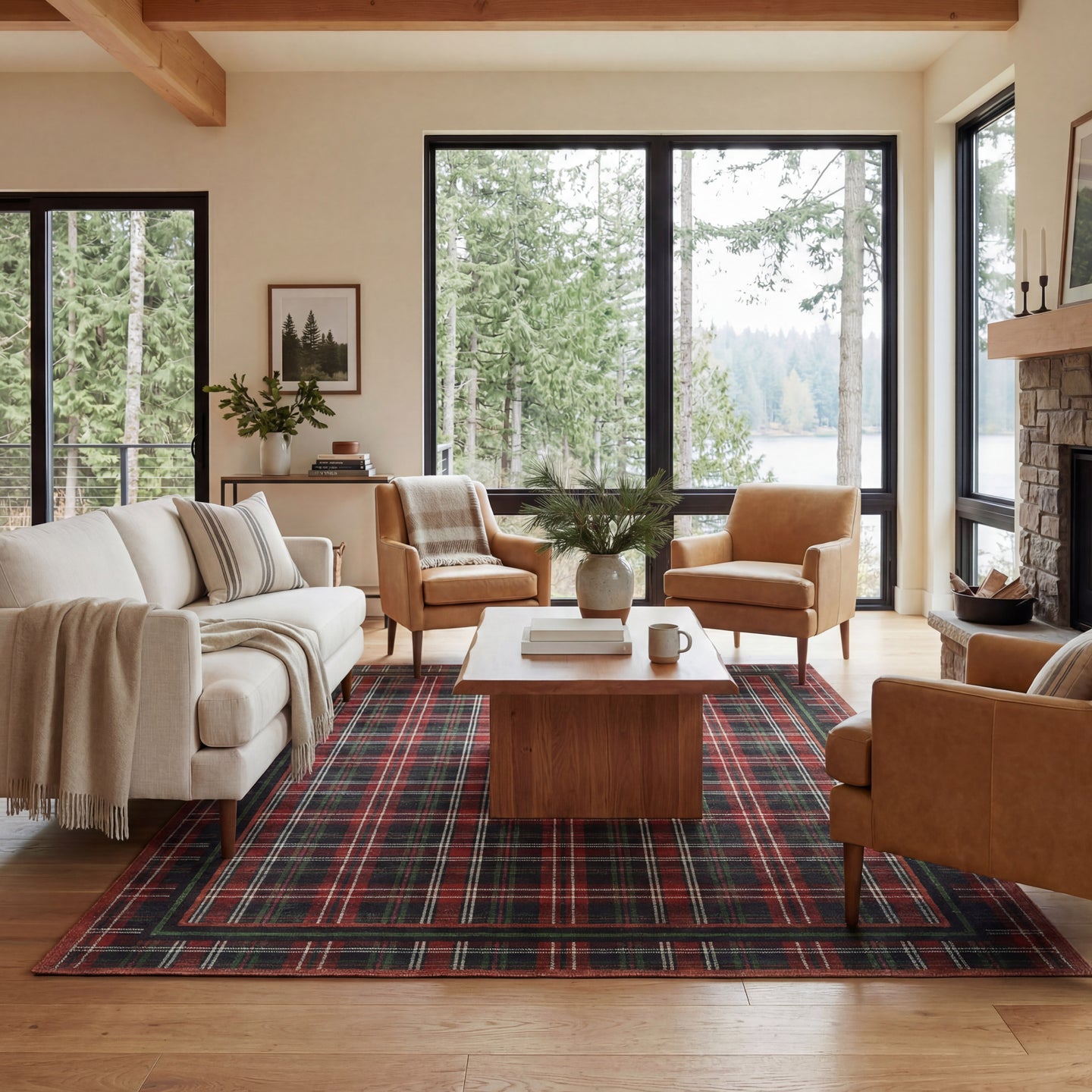 Living room with plaid rug, wooden coffee table, and large windows overlooking trees.