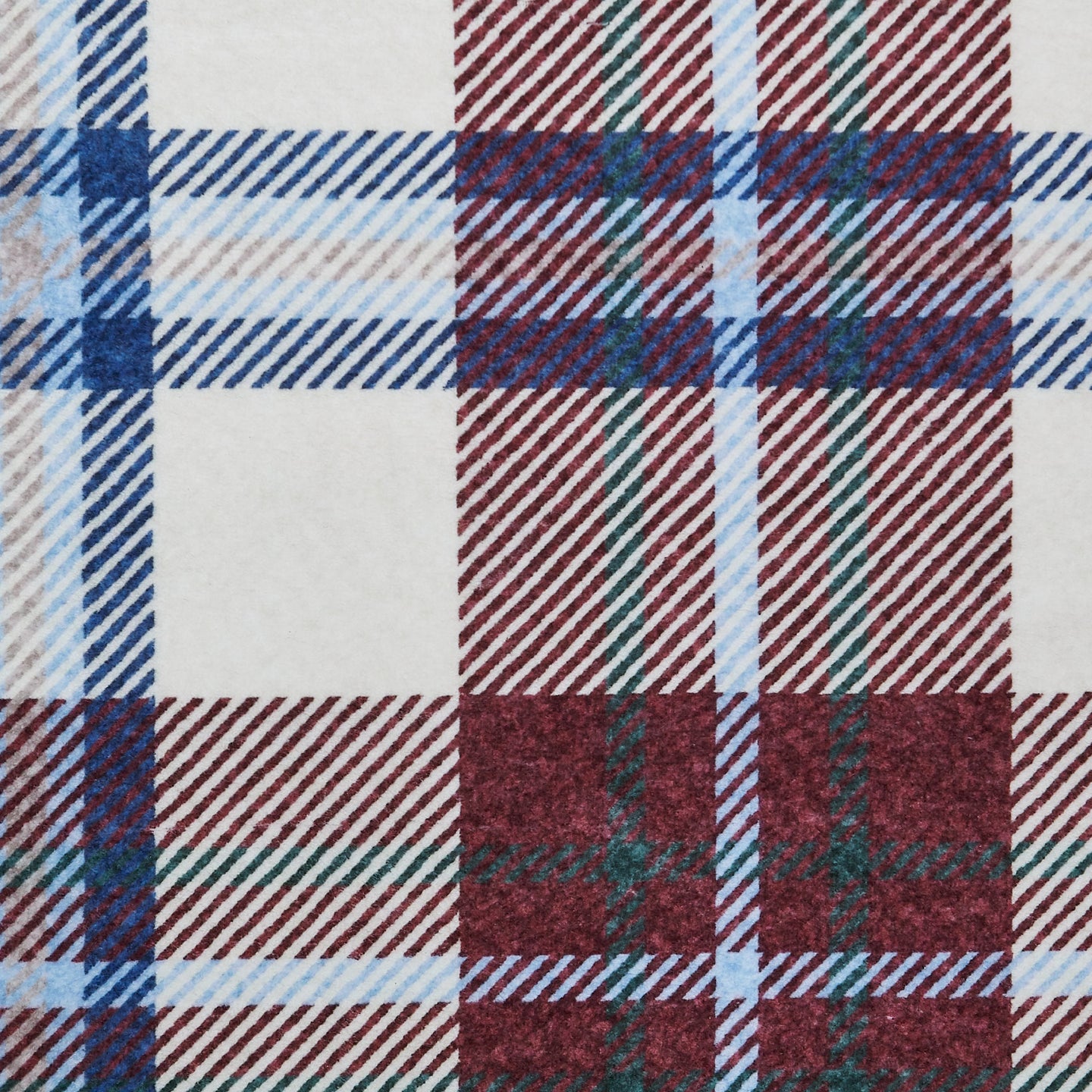 Close-up of a plaid fabric with brown, blue, and beige colors.