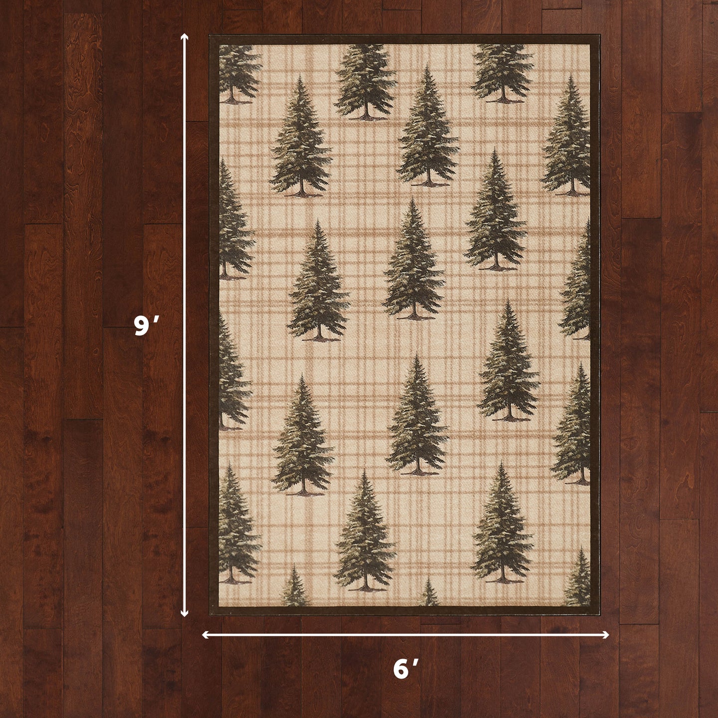 Framed rug with scattered pine tree pattern on cream and tan plaid background, 6' x 9'.