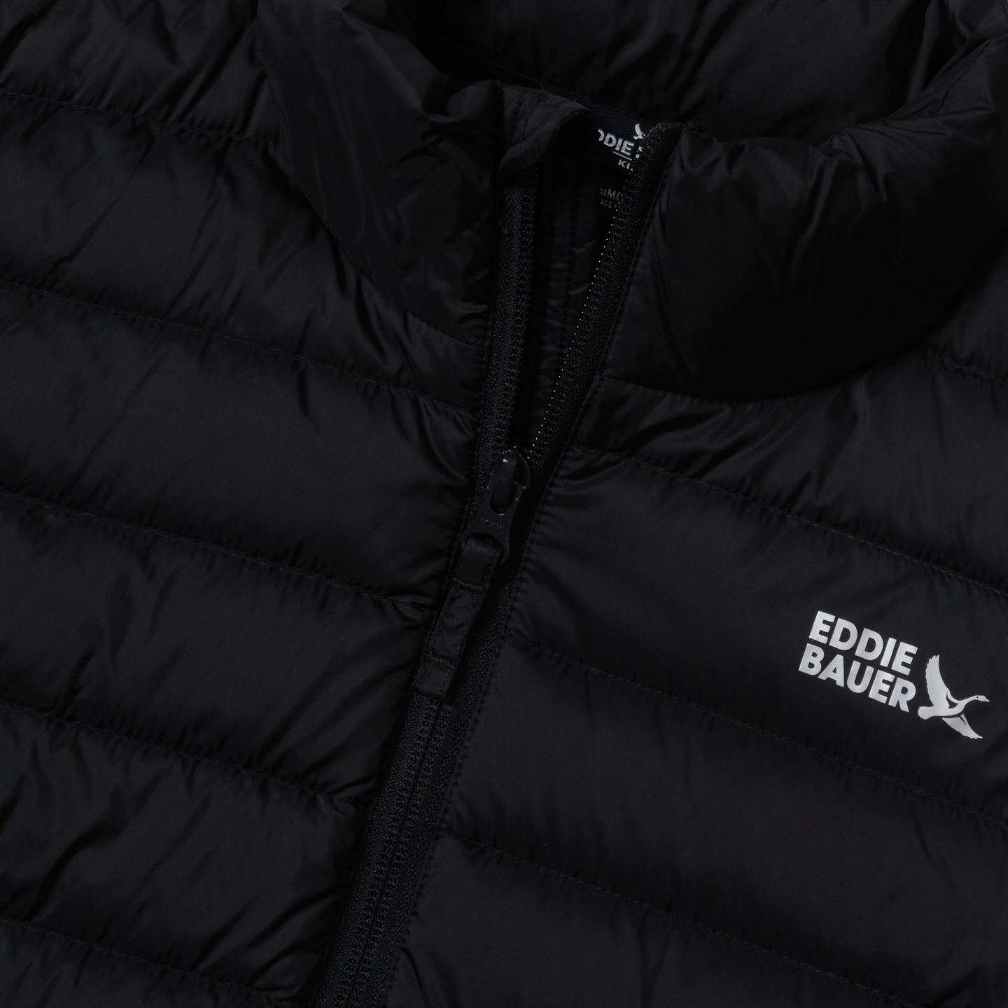 Black quilted down jacket with full-length zip and Eddie Bauer branding on chest.